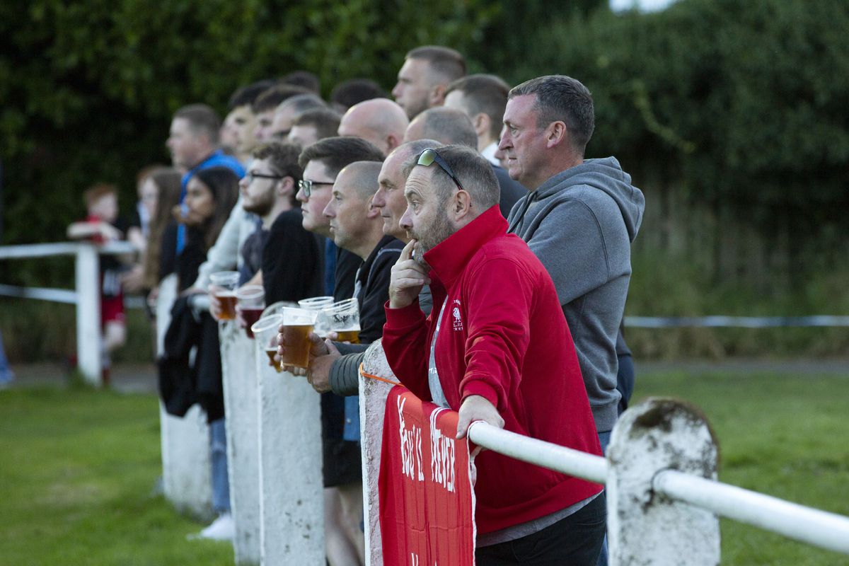 Spectators standing at the perimeter fence during the Extra Preliminary Round between Daisy Hill and Colne - New Sirs, Westhoughton - FA Cup