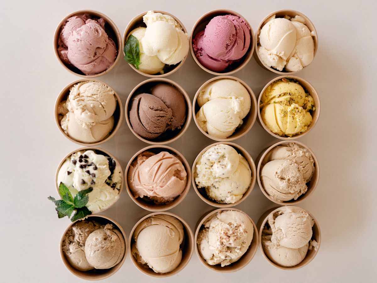 Sixteen scoops of Craft Creamery ice cream in small cardboard cups.