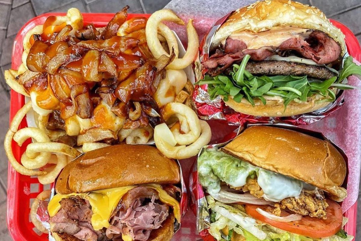 Four sandwiches on a tray.