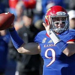 Kansas quarterback Jake Heaps (9) passes to a teammate during the first half of an NCAA college football game against Kansas State in Lawrence, Kan., Saturday, Nov. 30, 2013. (AP Photo/Orlin Wagner)