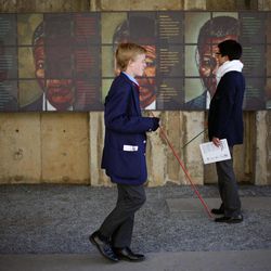 South African pupils watch a temporary exhibit on Nelson Mandela at the Apartheid Museum in Johannesburg Tuesday June 11, 2013. Former South African President Nelson Mandela is spending a fourth day in a hospital, where he is being treated for a recurring lung infection. 