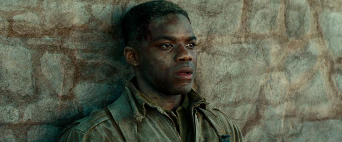Jovan Adepo leans against a wall in Overlord