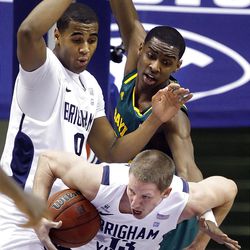 BYU's #13 Brock Zylstra ,front down, fights to control a rebound with teammate #0 Brandon Davies behind and Baylor's #30 Quincy Miller as BYU and Baylor play Saturday, Dec. 17, 2011 in the Marriott Center in Provo. Baylor won 86-83.