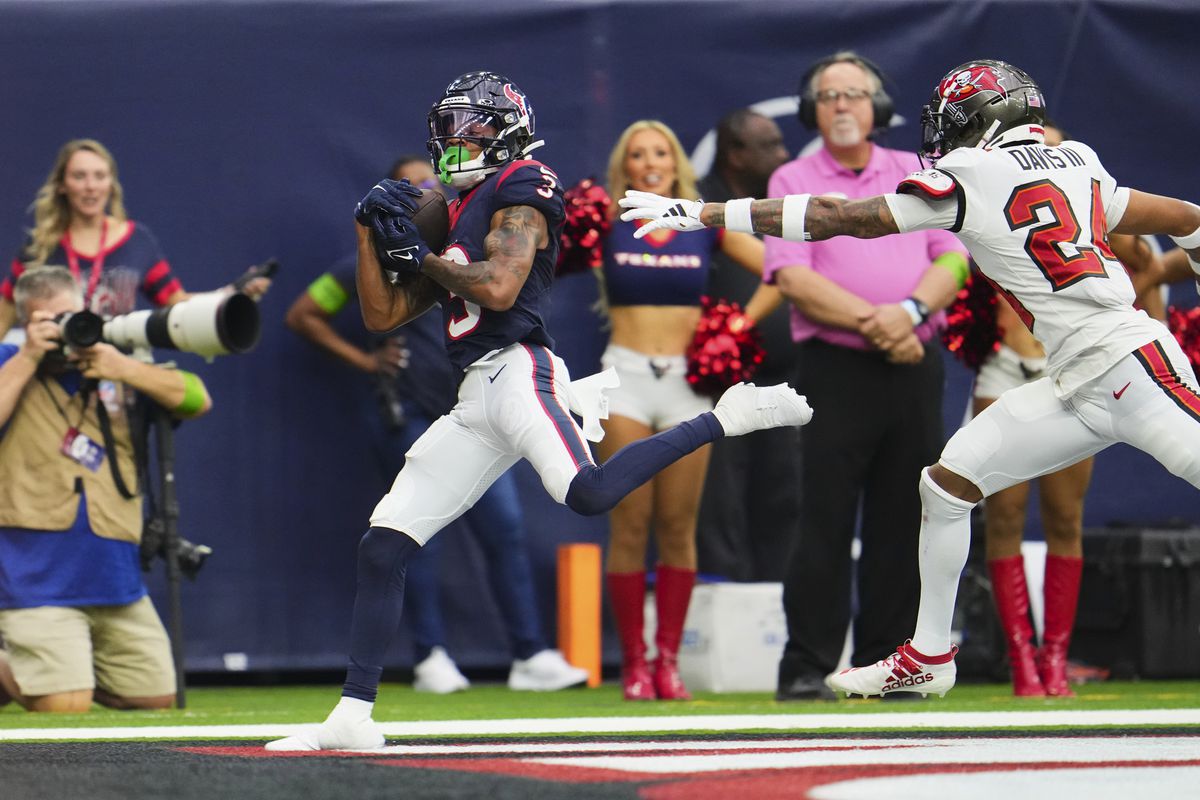 HOUSTON, TX - NOVEMBER 05: Tank Dell #3 of the Houston Texans catches a touchdown pass against the Tampa Bay Buccaneers during the second half at NRG Stadium on November 5, 2023 in Houston, Texas.