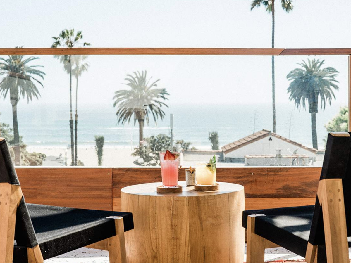 View of ocean and palm trees from a rooftop restaurant in Santa Monica.