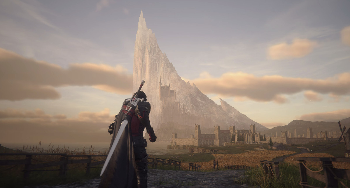 Clive, with a long sword slung on his back, jogs toward a medieval city with a towering mountain behind it in Final Fantasy 16