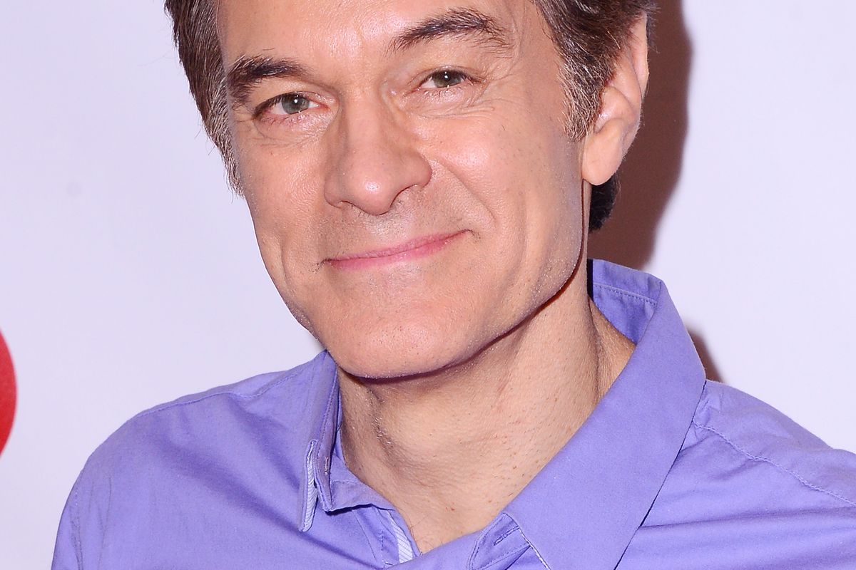 Dr. Mehmet Oz, in a purple collared shirt, smiling at the camera.