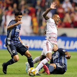 Real Salt Lake midfielder Everton Luiz (25) is taken down by Los Angeles Galaxy defender Diego Polenta (3) while Los Angeles Galaxy midfielder Joe Corona (14) takes the ball as Real Salt Lake and the LA Galaxy play at Rio Tinto Stadium in Sandy on Wednesday, Sept. 25, 2019.