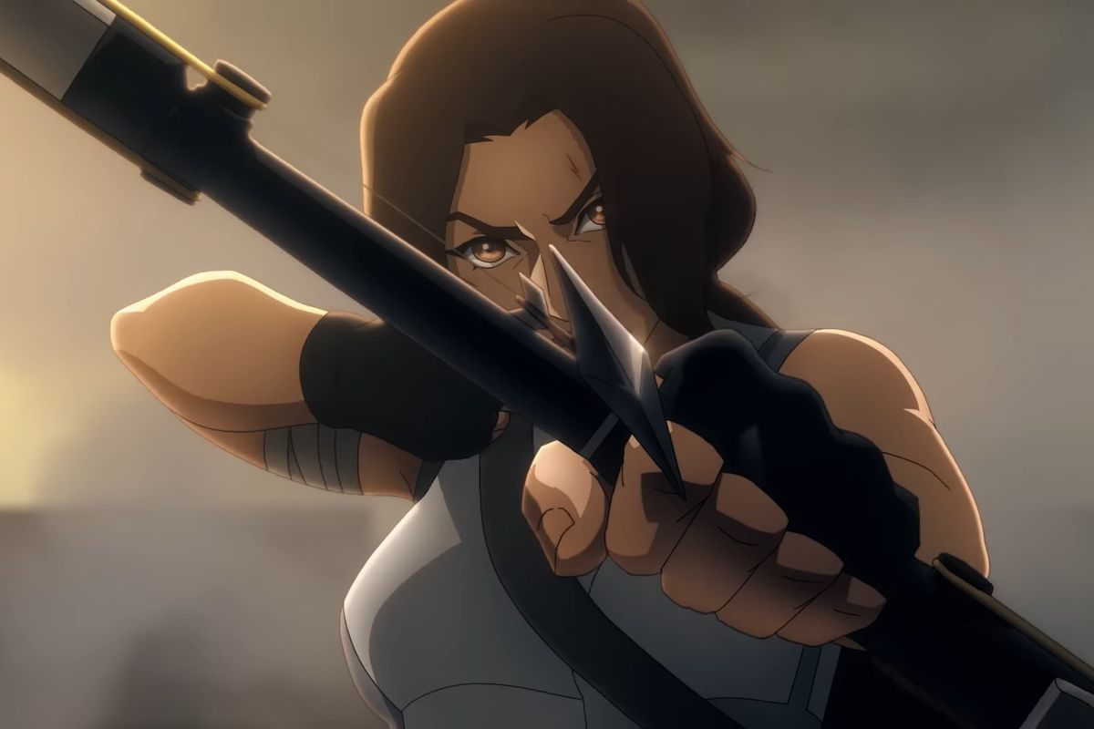 A still from the teaser trailer for Tomb Raider: The Legend Of Lara Croft, with Lara holding a nocked arrow in her bow, aiming toward the camera