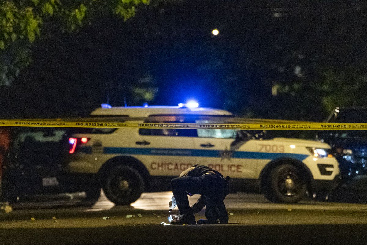 Chicago police work the scene where 27-year-old man was shot and killed in the 5600 block of S. Marshfield Ave, in the West Englewood neighborhood, Friday, June 4, 2021.