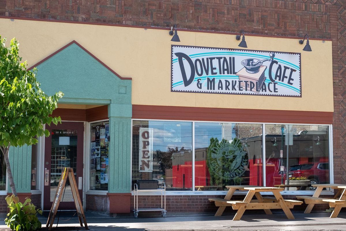 The exterior of Dovetail Cafe with picnic tables outside and big, open windows