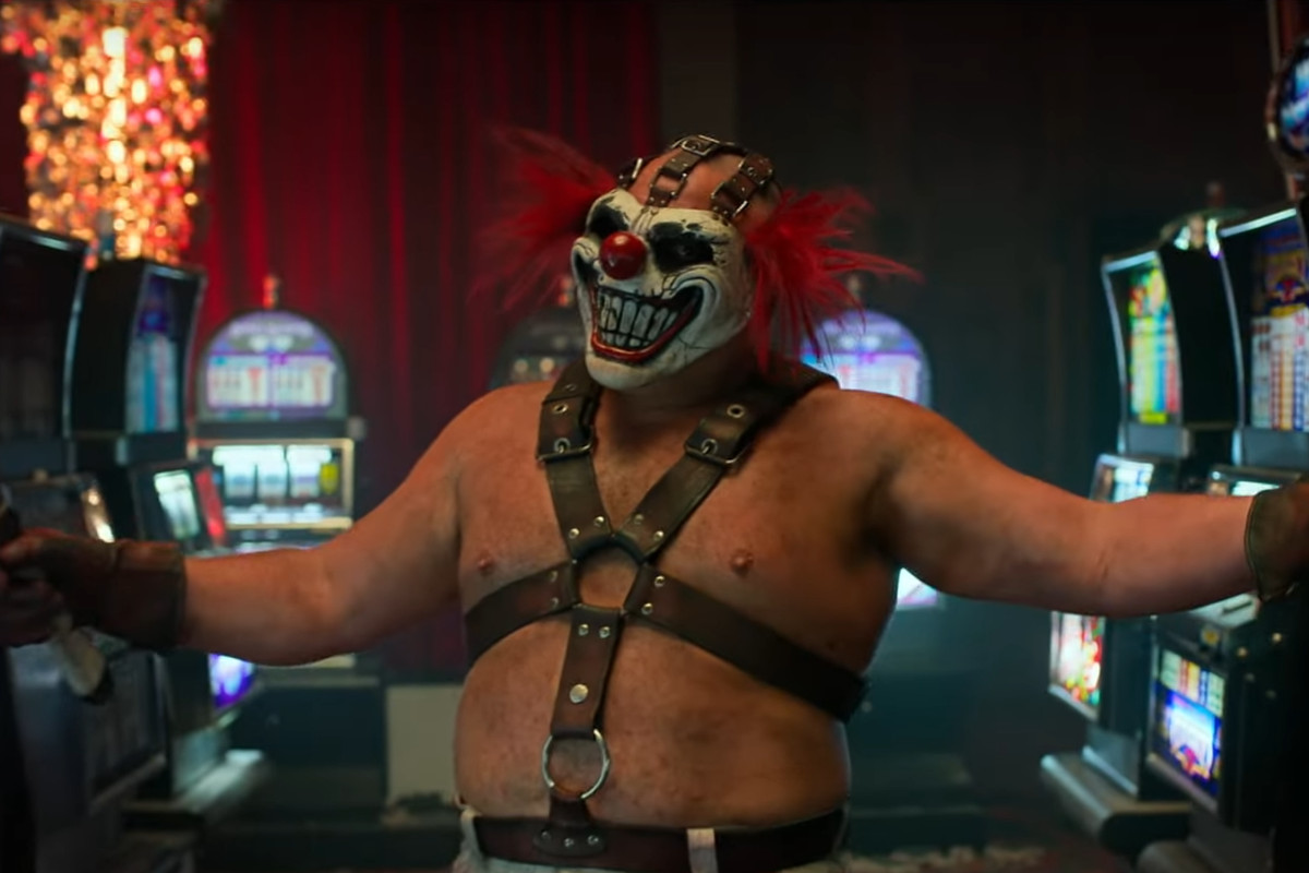 Sweet Tooth from the Twisted Metal tv show holding a machete and wearing his signature clown mask. 