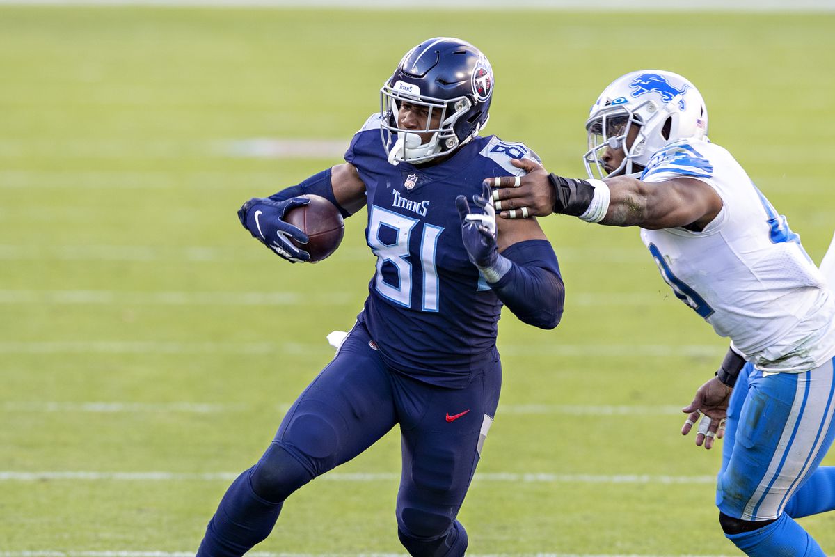 Tight end Jonnu Smith #81 of the Tennessee Titans runs the ball and is pushed out of bounds by linebacker Jarrad Davis #40 of the Detroit Lions at Nissan Stadium on December 20, 2020 in Nashville, Tennessee.