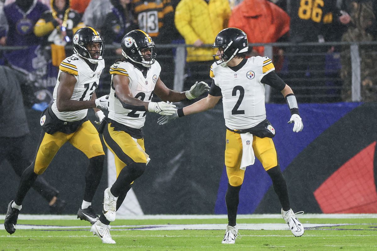 Mason Rudolph #2 of the Pittsburgh Steelers and Najee Harris #22 celebrate after a touchdown in the fourth quarter of a game against the Baltimore Ravens at M&amp;T Bank Stadium on January 06, 2024 in Baltimore, Maryland.