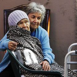 Cookie DiIorio, right, comforts her friend Hoan as they are evacuated from the Multi-Ethnic Senior Housing during a fire in Salt Lake City, Thursday, May 10, 2012. 