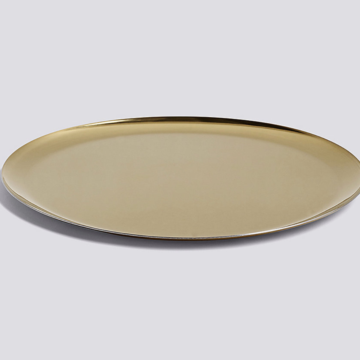 A gold, metallic tray that is circular. 