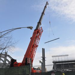 Steel beam being lifted on Waveland - 