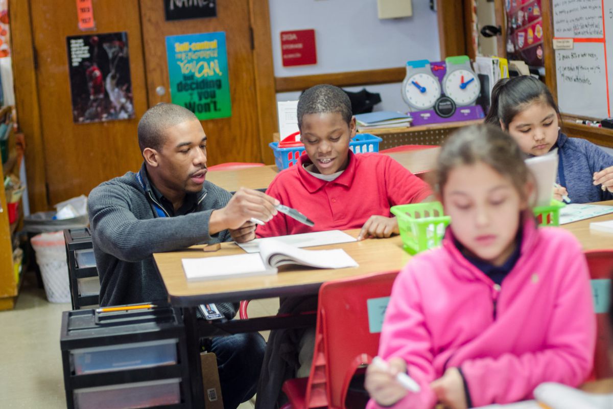 Treadwell Elementary math teacher Neven Holland, a graduate of the Memphis Teacher Residency program, helps his fourth-grade student with a problem.