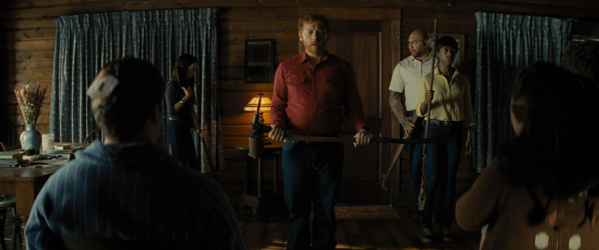 Rupert Grint with a weapon in Knock at the Cabin