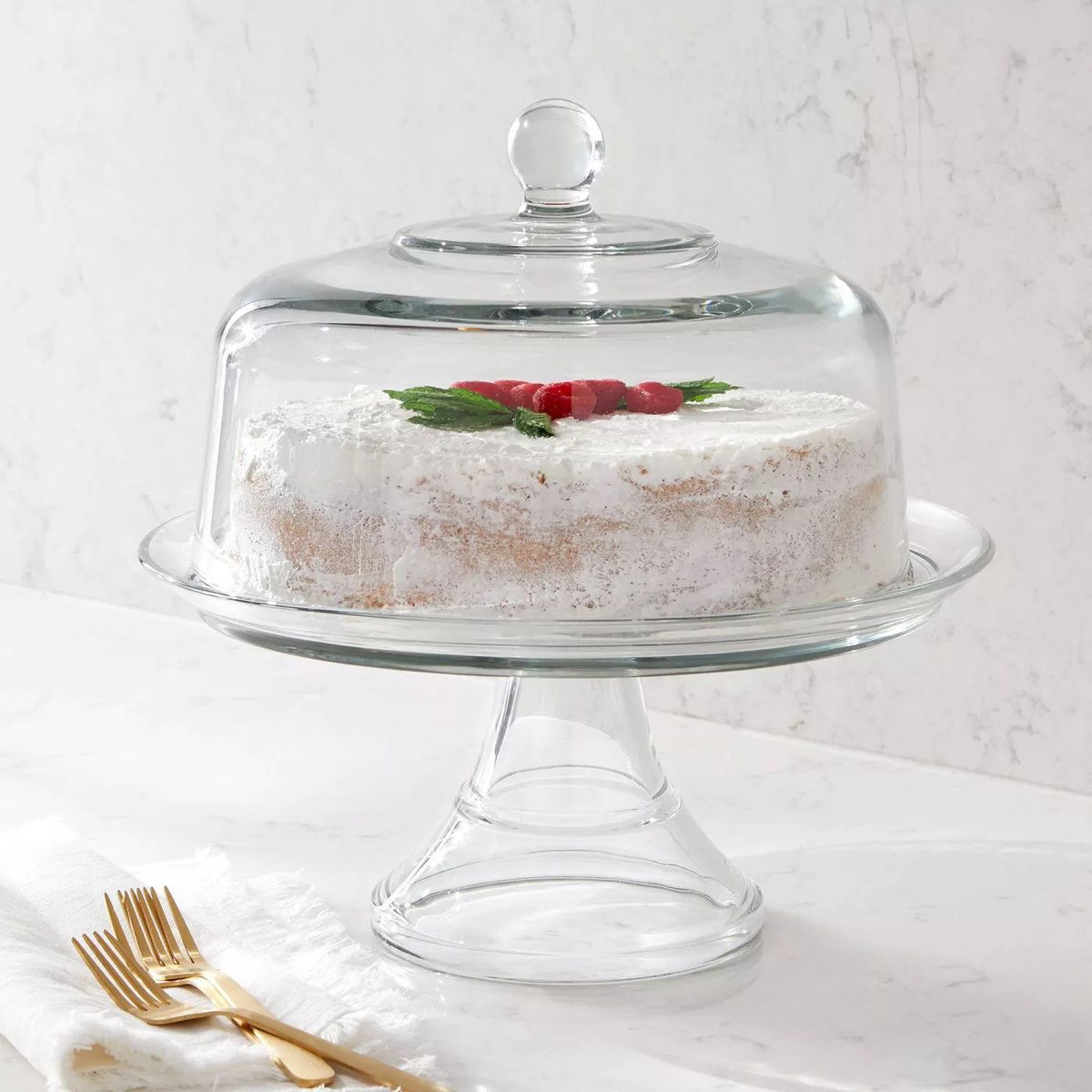 A glass cake stand with dome