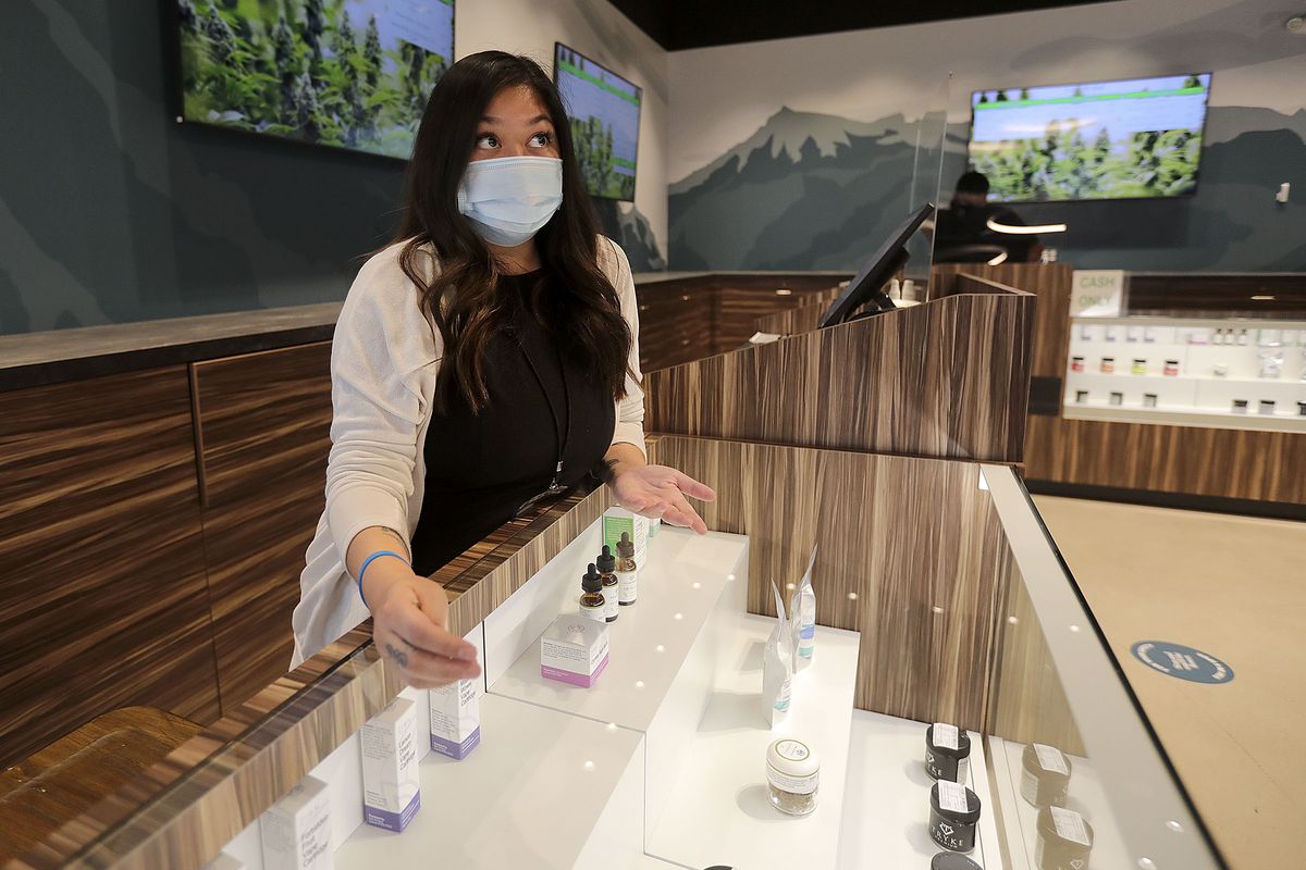Pharmacist Nadia Lian explains different products to a customer at Curaleaf, a cannabis dispensary, in Lehi on Wednesday, Sept. 23, 2020.