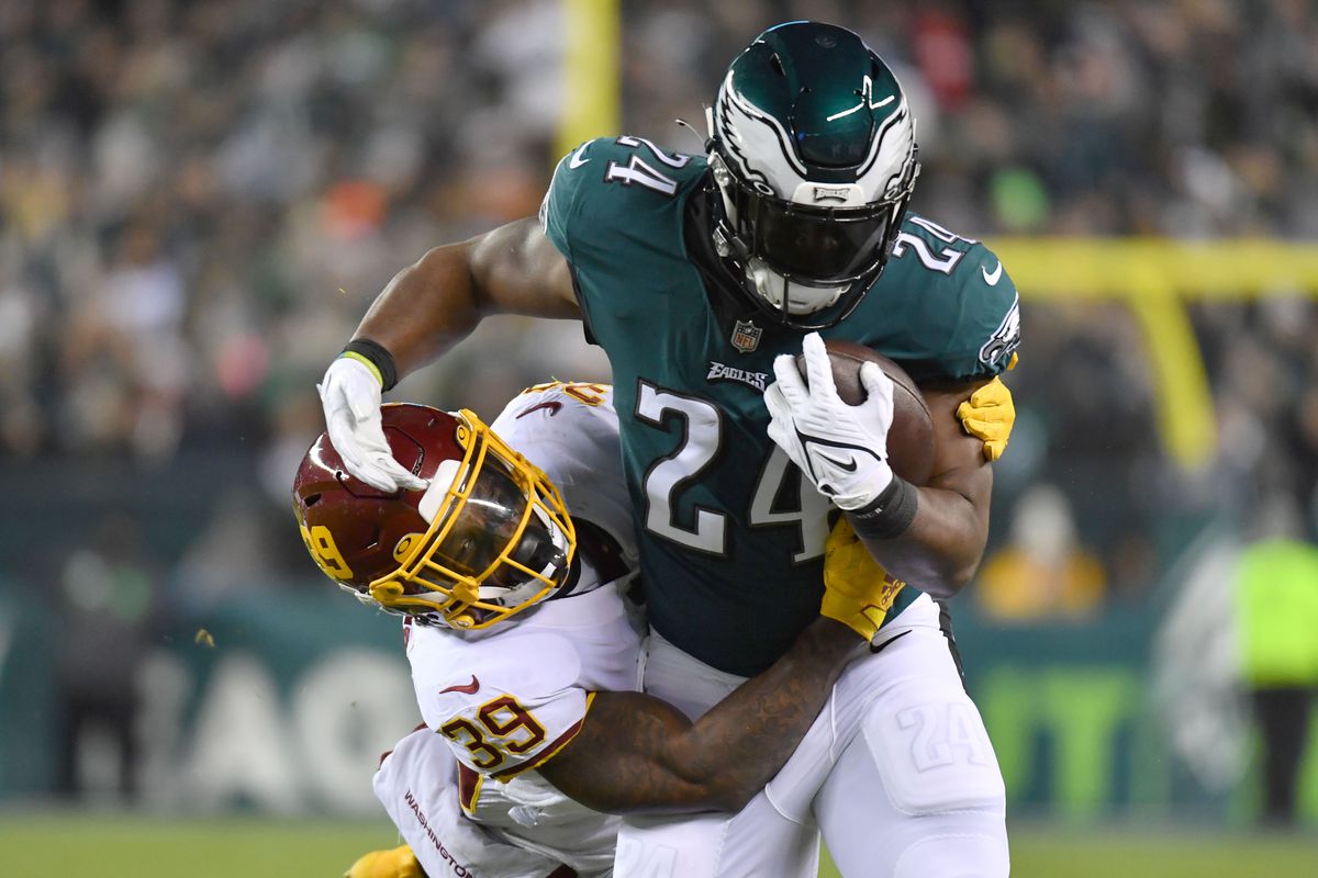 Philadelphia Eagles running back Jordan Howard (24) is tackled by Washington Football Team defensive back Jeremy Reaves (39) during the second quarter at Lincoln Financial Field.