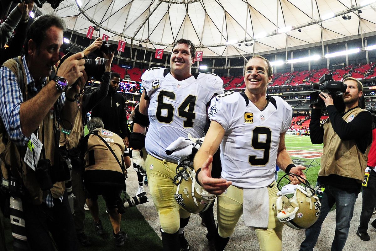 ATLANTA, GA - New Orleans Saints quarterback Drew Brees (9) and offensive tackle Zach Strief (64) celebrate after winning against the Atlanta Falcons in the last game played at the Georgia Dome on January 3, 2016.