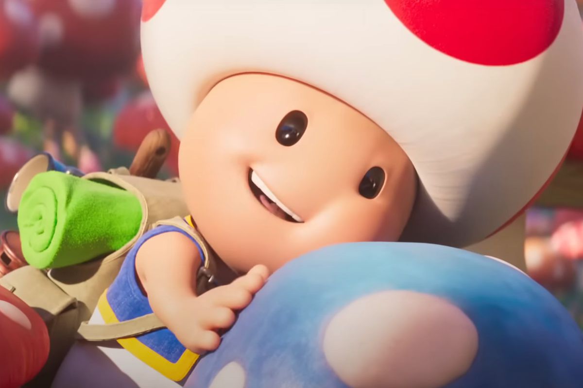 Toad embraces a blue mushroom with a smile in The Super Mario Bros. Movie
