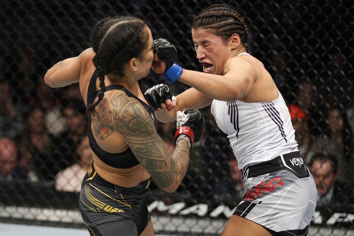 Julianna Pena punches Amanda Nunes of Brazil in their UFC bantamweight championship bout during the UFC 269 on December 11, 2021 in Las Vegas, Nevada.