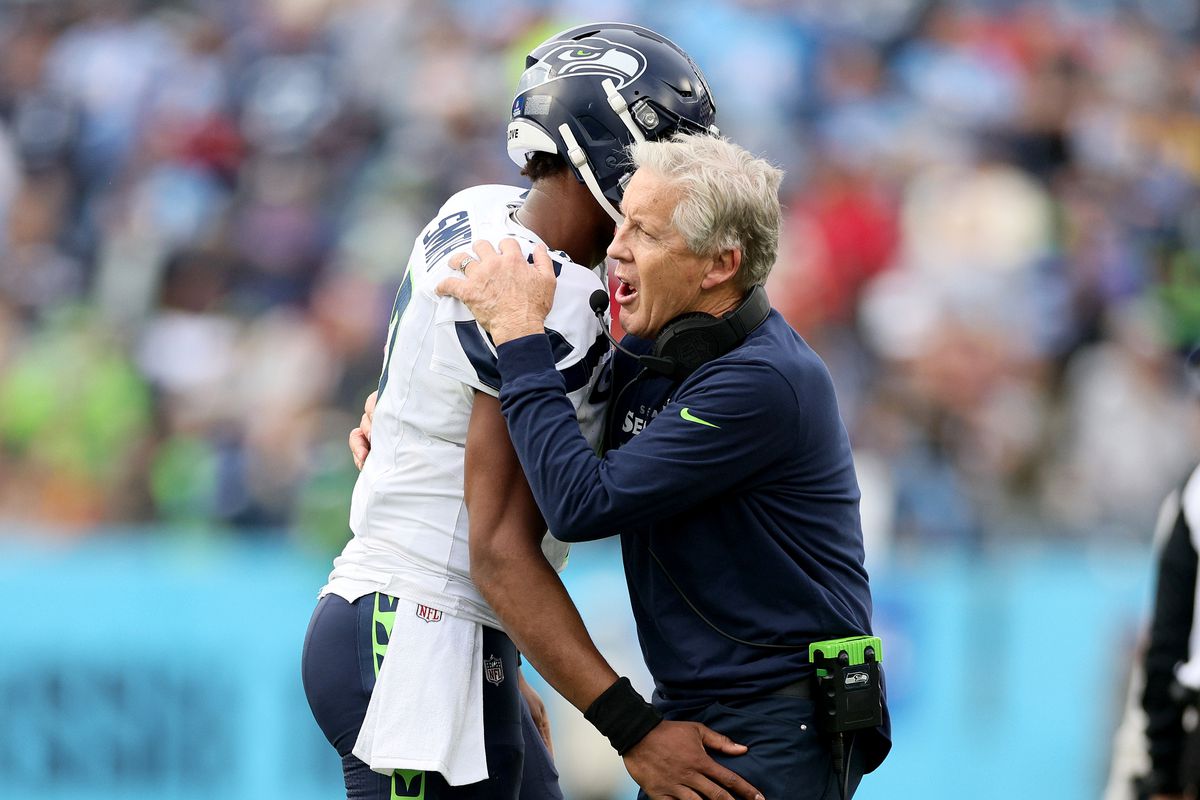 Pete Carroll the head coach of the Seattle Seahawks celebrates with Geno Smith #7 after Smith threw the game winning touchdown pass against the Tennessee Titans at Nissan Stadium on December 24, 2023 in Nashville, Tennessee.