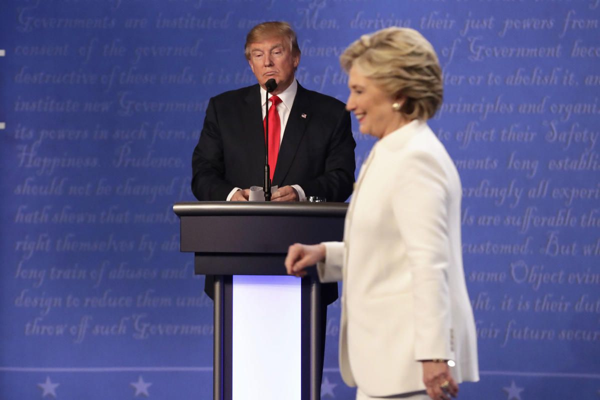 Republican presidential nominee Donald Trump waits behind his podium as Democratic presidential nominee Hillary Clinton makes her way off the stage following the third presidential debate at UNLV in Las Vegas, Wednesday, Oct. 19, 2016. (AP Photo/David Gol