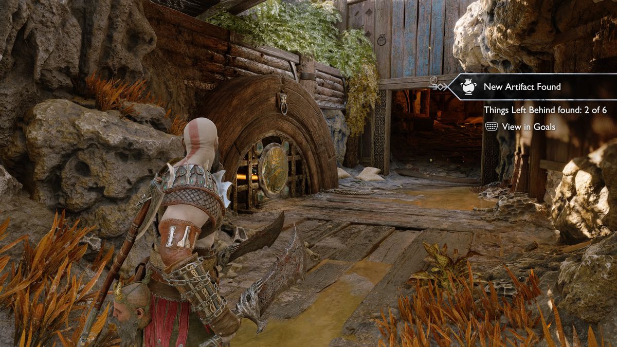 Kratos grabs an artifact in God of War Ragnarök