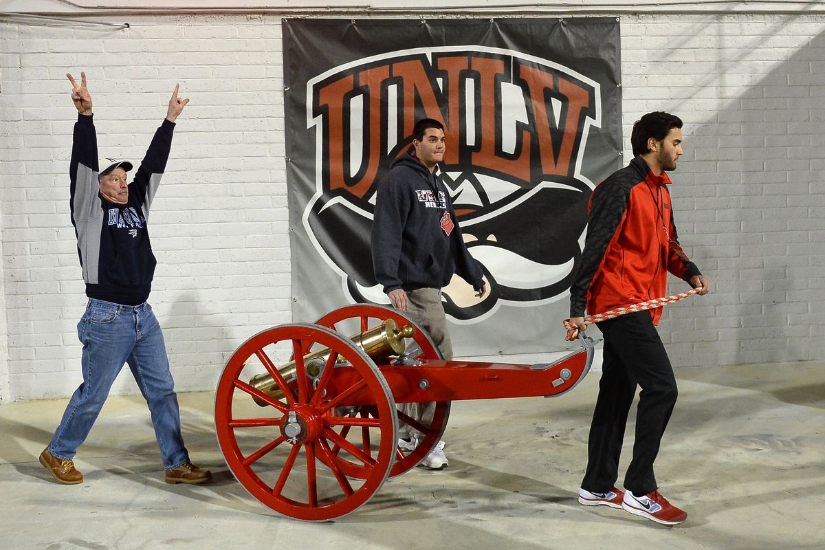 UNLV Athletics operations staff members take the Fremont Cannon trophy from the field to the Nevada Wolf Pack locker room late in the team’s game against the UNLV Rebels at Sam Boyd Stadium on November 29, 2014 in Las Vegas, Nevada. Nevada won the trophy with a 49-27 victory.