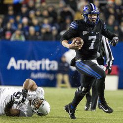 Brigham Young quarterback Taysom Hill (7) scrambles with the ball during an NCAA college football game against Utah State in Provo on Saturday, Nov. 26, 2016. Brigham Young defeated in-state foe Utah State 28-10.