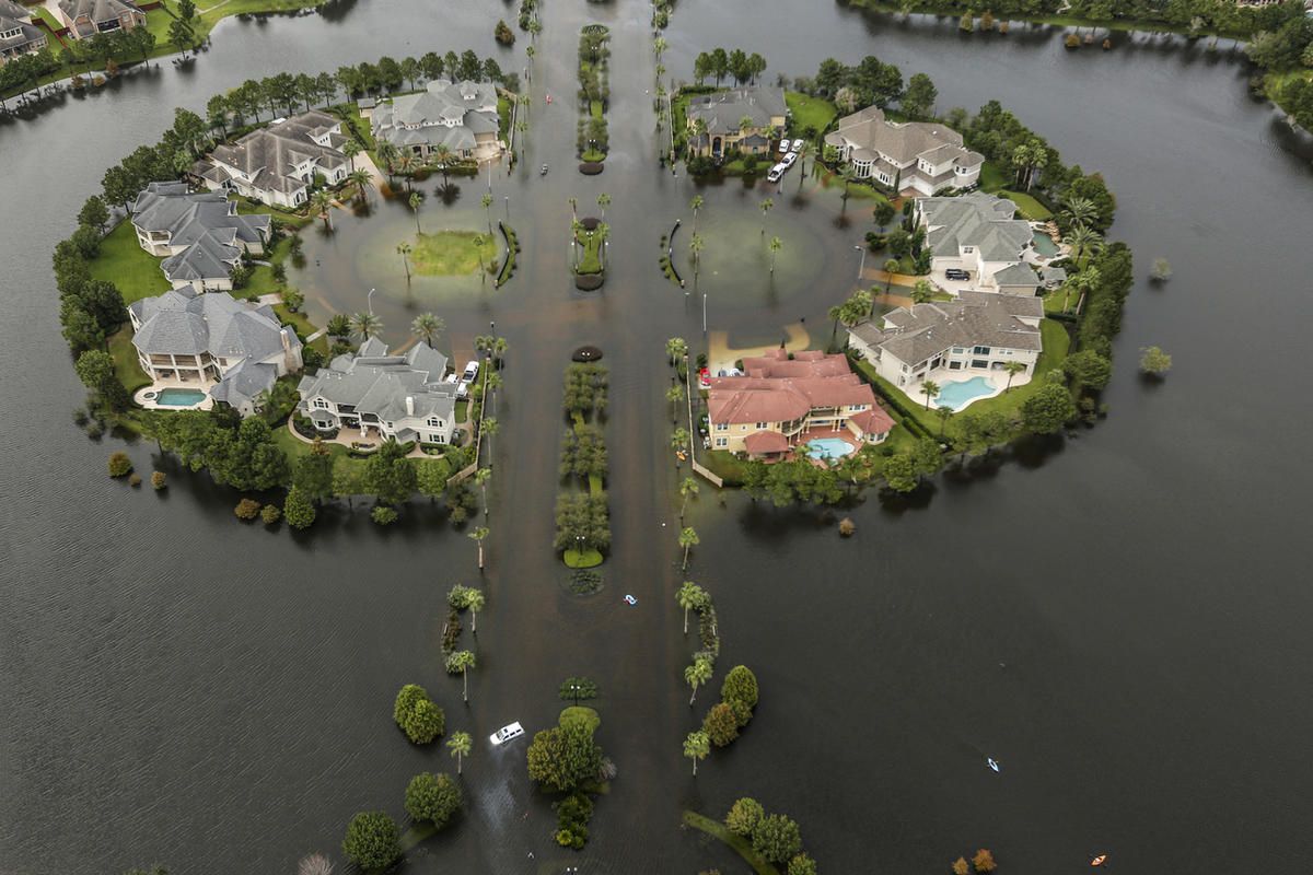 Floodwaters fill the road running through the Lakes On Eldridge North subdivision in the aftermath of Tropical Storm Harvey on Wednesday, Aug. 30, 2017, in Houston. (Brett Coomer/Houston Chronicle via AP)
