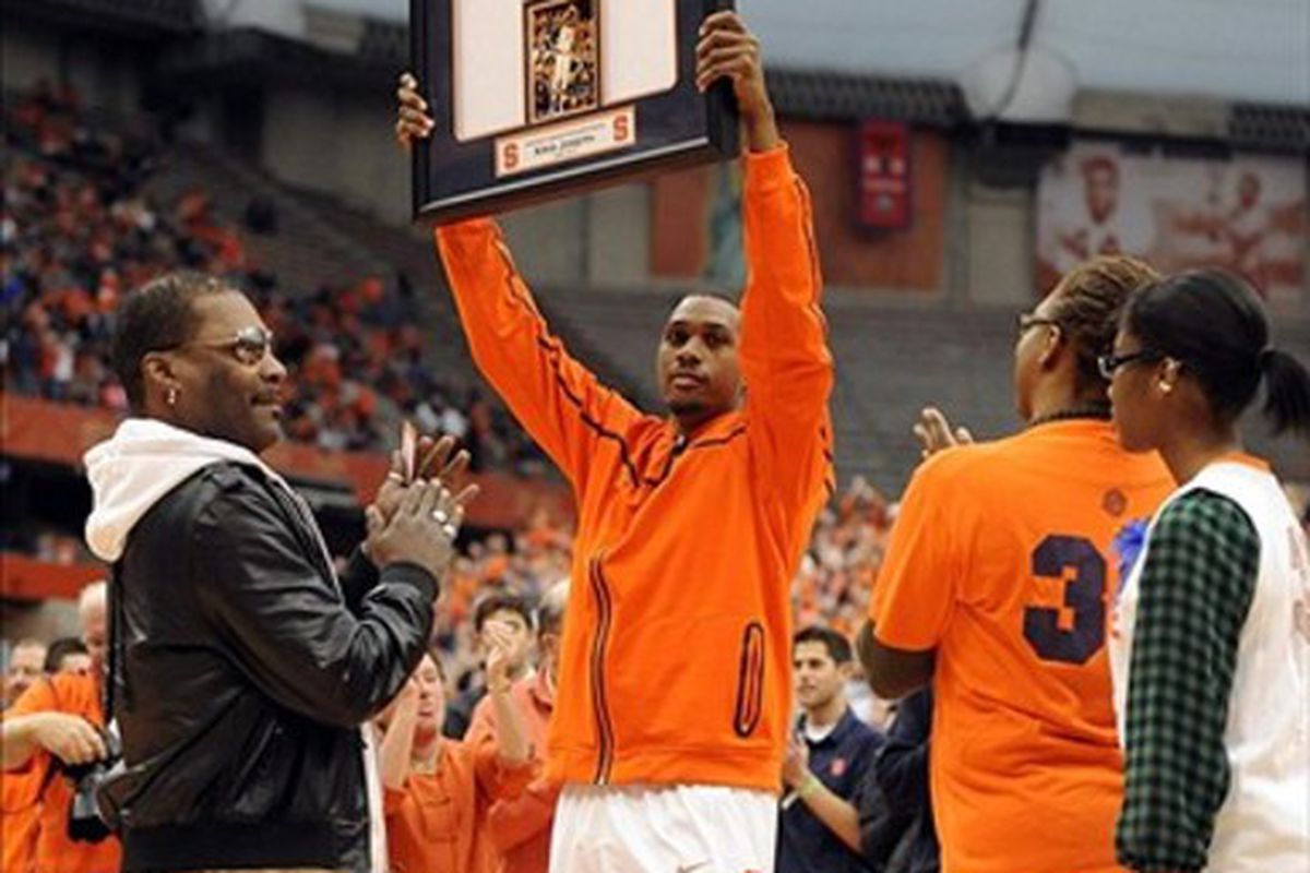 Mar 3, 2012; Syracuse, NY, USA; Syracuse Orange forward Kris Joseph (32) hoists a framed jersey during senior day festivities before the game against the Louisville Cardinals at the Carrier Dome.  Richard Mackson-US PRESSWIRE