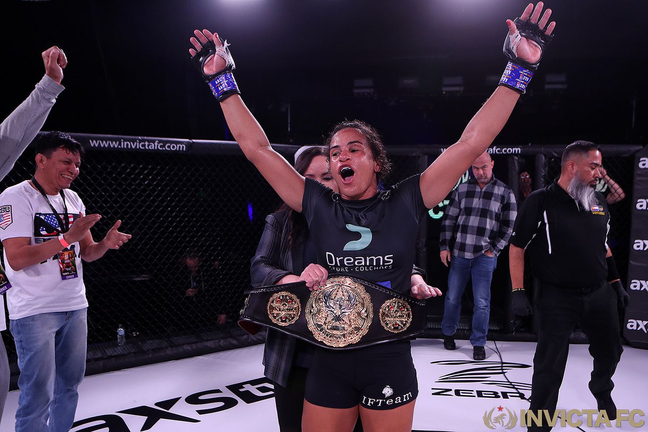 Talita Bernado celebrates with the bantamweight title belt after beating Taneisha Tennant at Invicta FC 51.