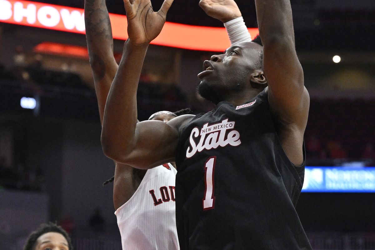 New Mexico State Aggies forward Kaosi Ezeagu shoots against the Louisville Cardinals during the first half at KFC Yum! Center.