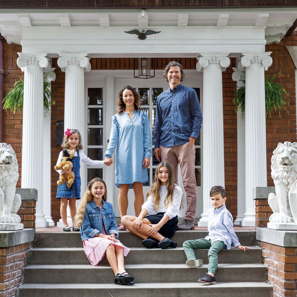 The Beller family in front of their renovated home