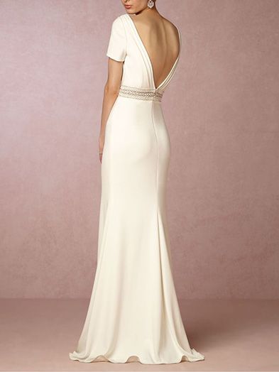 Model in classic crepe wedding gown with natural waist silhouette. 