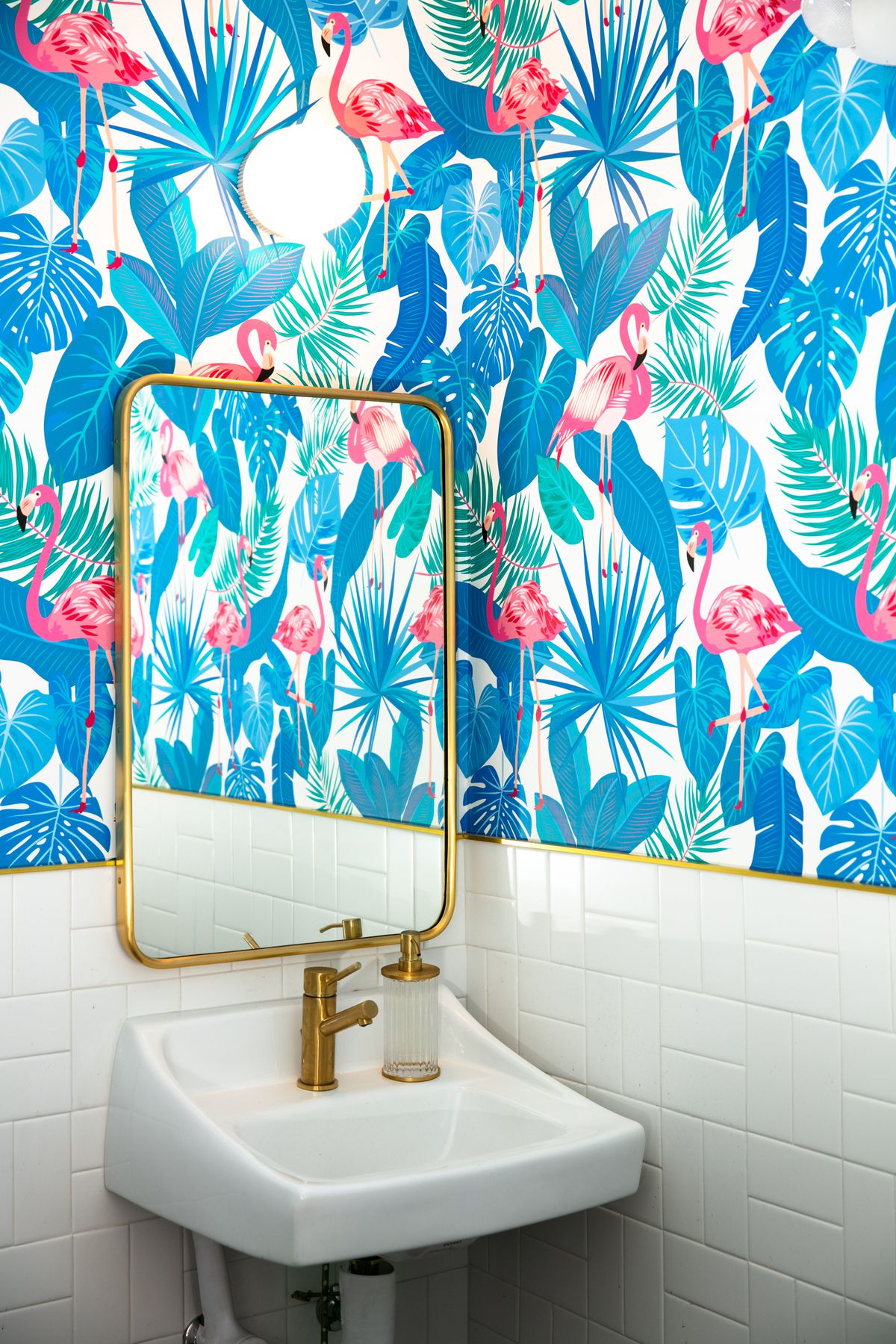 Leaf print blue wallpaper with flamingos in the bathroom at AL’s Deli