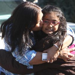 A woman hugs her daughter after being reunited at the Sandy Hook firehouse after a mass shooting at the Sandy Hook Elementary School in Newtown, Conn. 