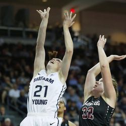 Brigham Young Cougars guard Lexi Eaton Rydalch (21)  shoots by Santa Clara Broncos forward Devin Hudson (32) during the WCC tournament in Las Vegas Monday, March 7, 2016. BYU won 87-67.