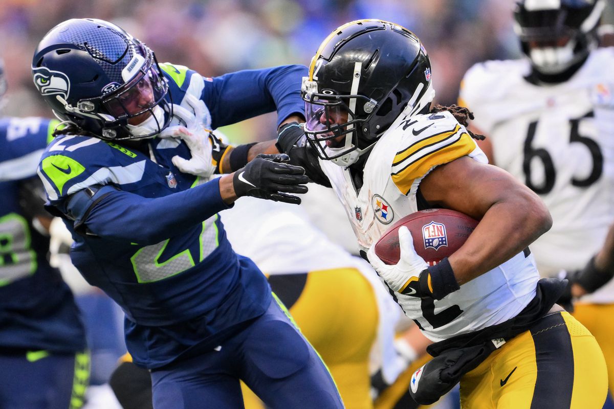 Najee Harris #22 of the Pittsburgh Steelers runs for a first down against the Seattle Seahawks during the fourth quarter at Lumen Field on December 31, 2023 in Seattle, Washington.