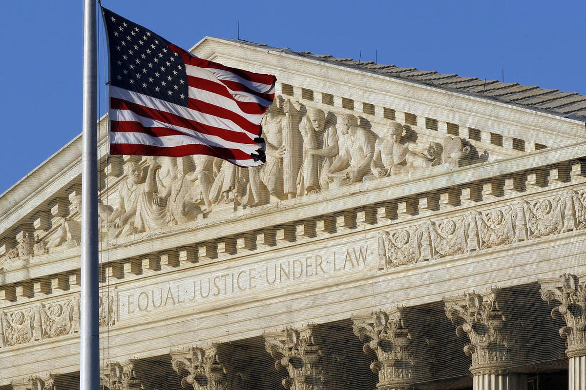 An American flag flies in front of the U.S. Supreme Court.
