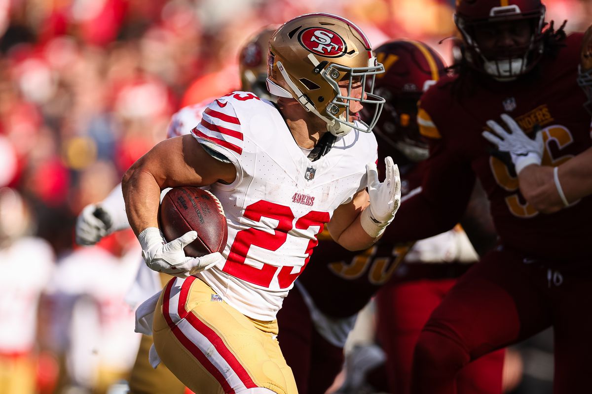 Christian McCaffrey #23 of the San Francisco 49ers carries the ball against the Washington Commanders during the first half of the game at FedExField on December 31, 2023 in Landover, Maryland.
