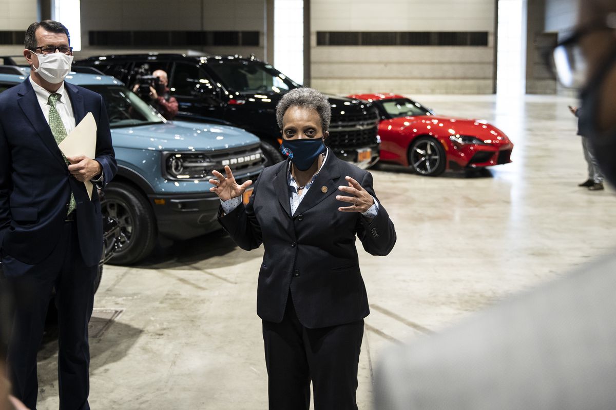Mayor Lori Lightfoot speaks with supporters Tuesday after it was announced that the Chicago Auto Show will take place in July at McCormick Place.