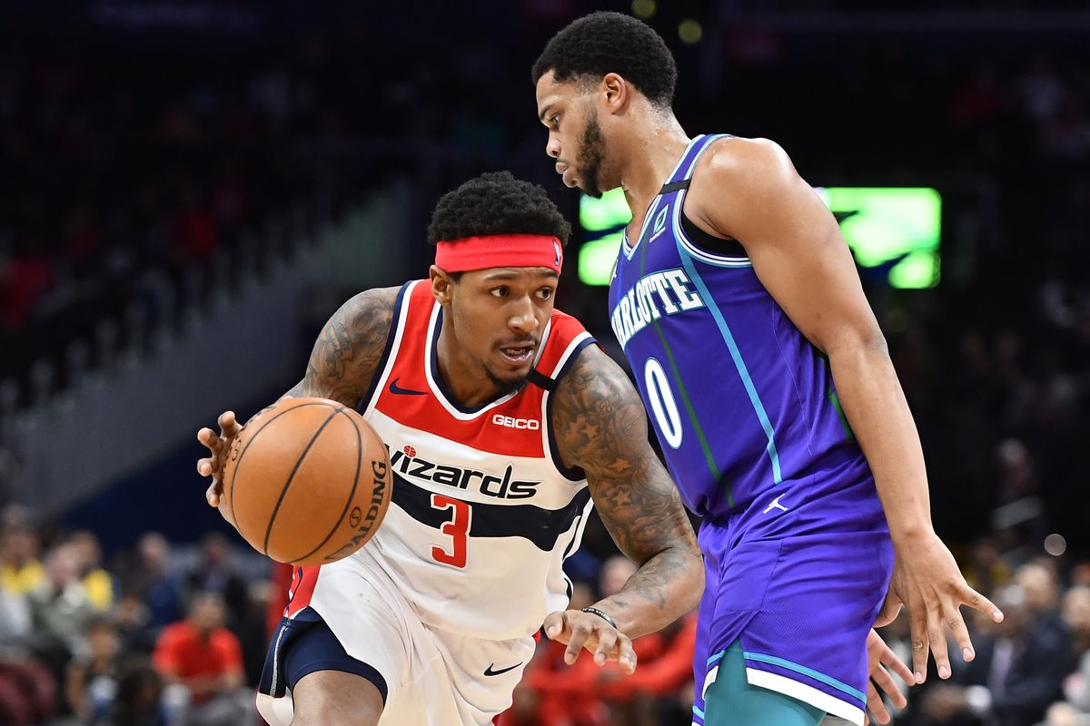 Washington Wizards guard Bradley Beal dribbles past Charlotte Hornets forward Miles Bridges during the third quarter at Capital One Arena.