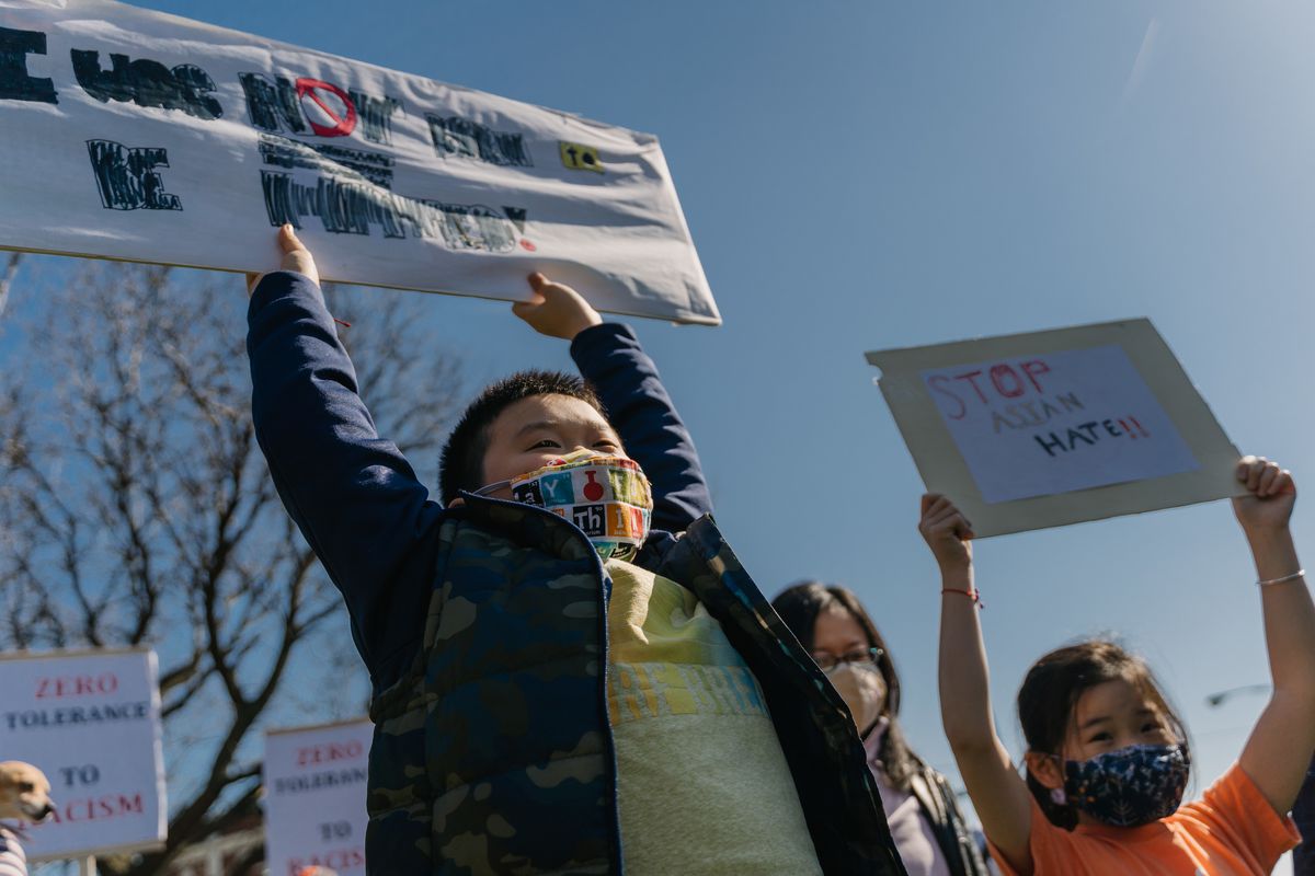 Dylan Fan (left), 10, and Olivia Xie, 9, of Hyde Park, chant and raise a sign they made for the Stop Asian Hate March at the Illinois Centennial Monument in Logan Square, Saturday afternoon, March 20, 2021.