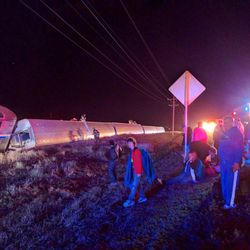 Passengers gather after a train derailed near Dodge City, Kan., Monday, March 14, 2016. An Amtrak statement says the train was traveling from Los Angeles to Chicago early Monday when it derailed just after midnight. 